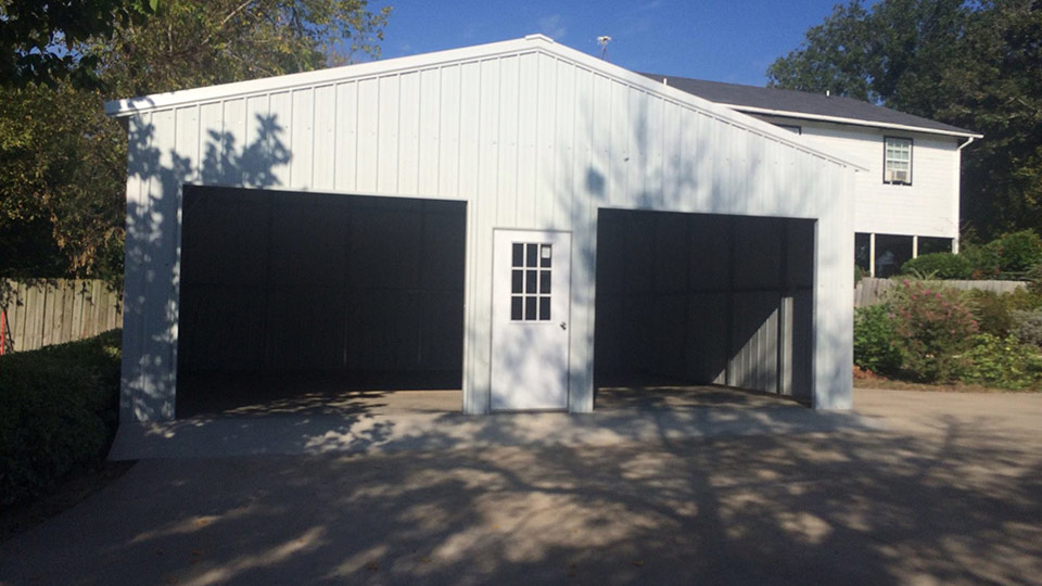 All white garage with twin roll up doors